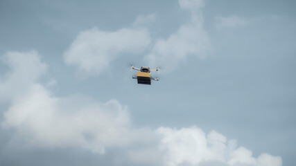 flying on a sky delivery drone with holding a .cardboard parcel