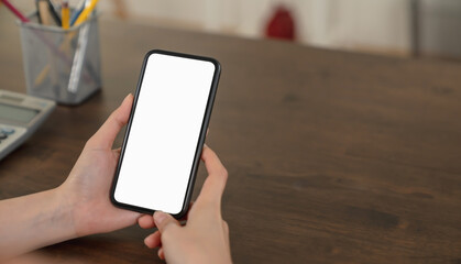 Woman hand holding smartphone and touching blank screen. Mockup of advertisement.