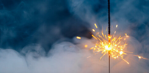 fire sparkler in dense smoke, abstract Christmas firework background