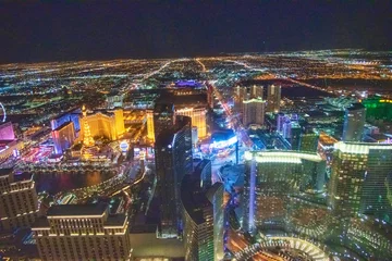 Schilderijen op glas LAS VEGAS, NV - JUNE 29, 2018: Night aerial view of Casinos and Hotels along The Strip. This is the famous city road full of Casinos and Hotels © jovannig