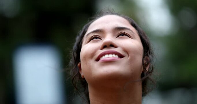 Young woman opening eyes and smiling, feeling happy and free
