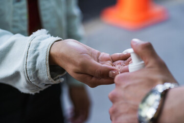 hand taking antibacterial gel