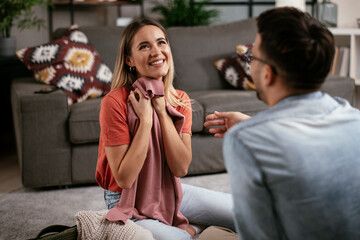 Loving couple packing clothes into travel bag. Boyfriend and girlfriend preparing for the trip..