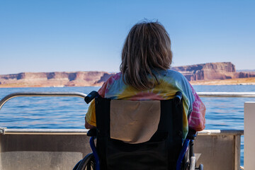 Fototapeta premium Woman in wheelchair on boat at Lake Powell enjoys the vista