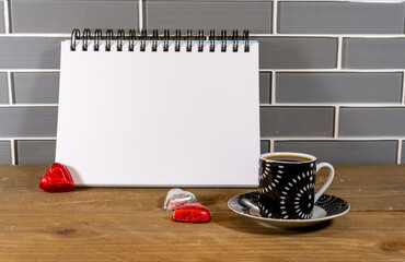Blank spiral notepad in a modern kitchen with espresso and candy hearts