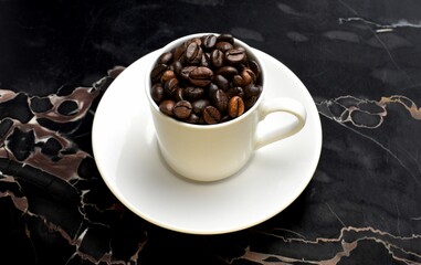 cup of coffee beans on marble 
