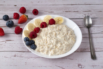 Healthy food. Oatmeal, raspberries, blueberries, banana.