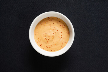 sauce in white bowl, top view