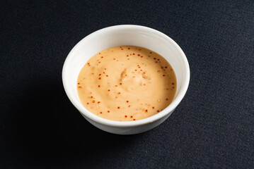 sauce in white bowl, top view