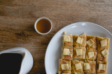 Set of Chinese tea and pancake on a wooden table.