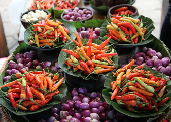 Colorful chilies and shallots at a traditional market.