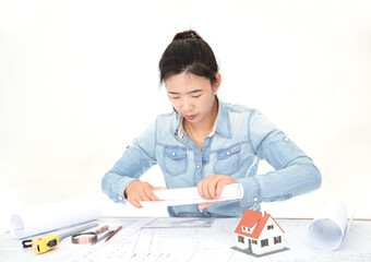 The architect rolls up the construction drawings on the desk