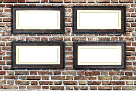 Four empty picture frames on old brick wall