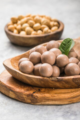 Chocolate balls filled with hazelnuts on a white background