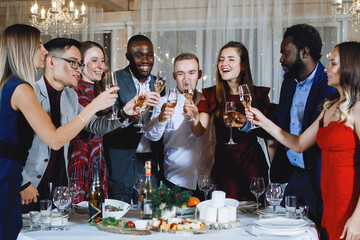 Company of young multinational people at the table.
