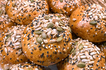 Whole grain bread bun containing sesame, pumpkin seeds, sunflower seeds topping