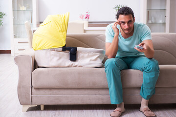 Fototapeta premium Young male parent looking after newborn at home