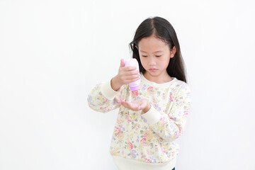 Little asian girl pouring talcum powder on hand over white background