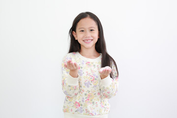 Cheerful asian little girl with lotion cream in hands on white background.