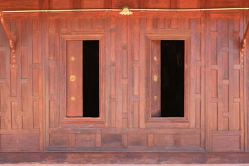 Open window. Thai style wooden windows on brown wood wall background