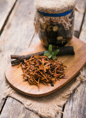 Comfrey root ( Symphytum)  on a table with honey collected in spring, on a table