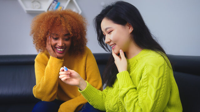 Happy lesbian couple with positive pregnancy test. family planing concept. High quality photo