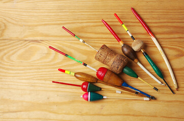 Homemade fishing floats made by hand on a wooden table. © yrafoto