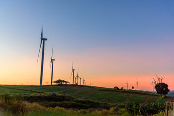 Fototapeta na wymiar wind turbines park for make the electric power from wind in sunset time