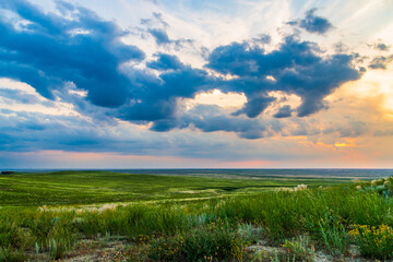 Scenic sunset with clouds in sky in steppe