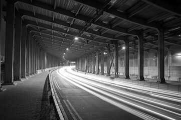 Fototapeta na wymiar light trails and head lights of traffic in tunnel
