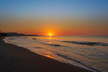 Fototapeta na wymiar A peaceful sunrise on a beach on the Costa Azahar