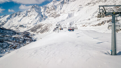 Panorama of Cervinia Cervinia ski resort, Italy. Beautiful landscape in the Alps. Ski chair lifts with skiers