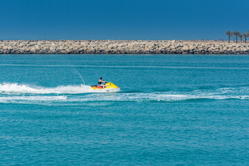Obraz premium Tourist riding jet ski in the Persian bay in Abu Dhabi, United Arab Emirates