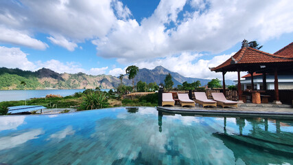 Fototapeta na wymiar Luxury swimming pool with mountain background