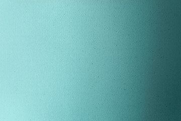 Teal gradient with pale turquoise or blue green color paint on cardboard box craft recycled paper background. Tidewater Green colour trends 2021