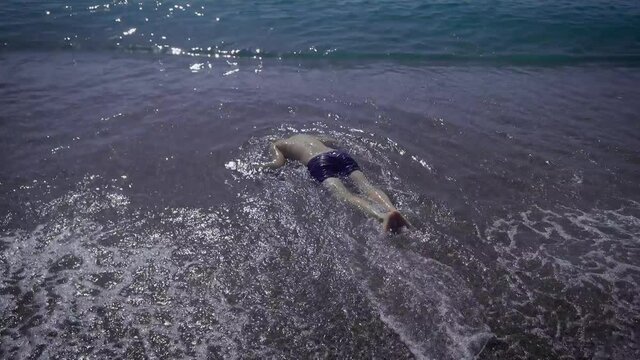 The body of an adult man who drowned at sea. Alcoholism on the water is very dangerous. The drowned man will be found by rescuers.