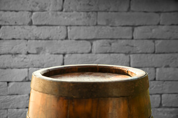 Fototapeta premium Old wooden barrel on a brown background