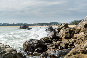 Seascape of waves splashing the stones in the rocky coastline of Yangxi, Yangjiang of China