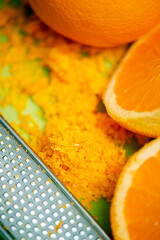 Closeup of grated fresh orange zest, food background.