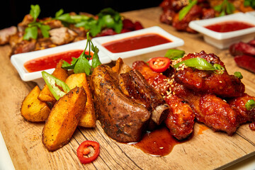 Pork ribs with baked potatoes and tomato sauce