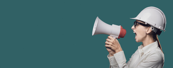 Fototapeta premium Aggressive businesswoman shouting through a megaphone