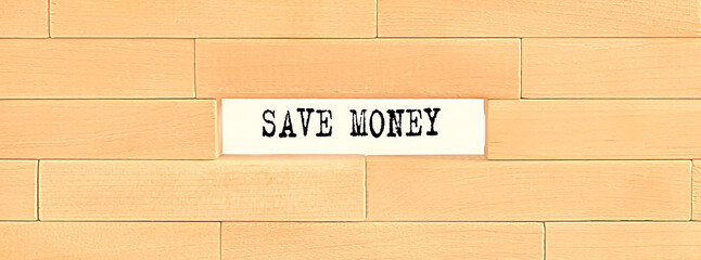 SAVE MONEY text on wooden block wall, business