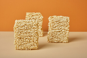 three block dry instant noodles on brown background