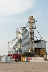 Obraz premium silver silos on agro manufacturing plant for processing drying cleaning and storage of agricultural products, flour, cereals and grain. Large iron barrels of grain. Granary elevator