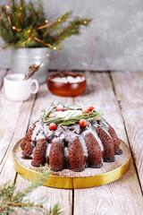  Christmas chocolate cake decorated with berries and rosemary on the table