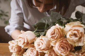 young woman florist in her studio makes a beautiful bouquet. Working moments