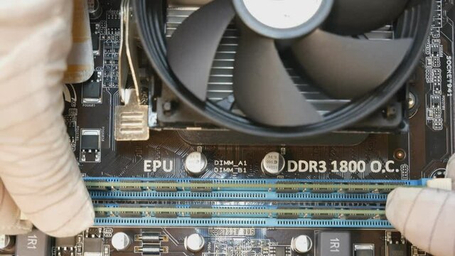 Kirovograd, Ukraine, November 14, 2020 - installing a RAM strap into the motherboard of a personal computer