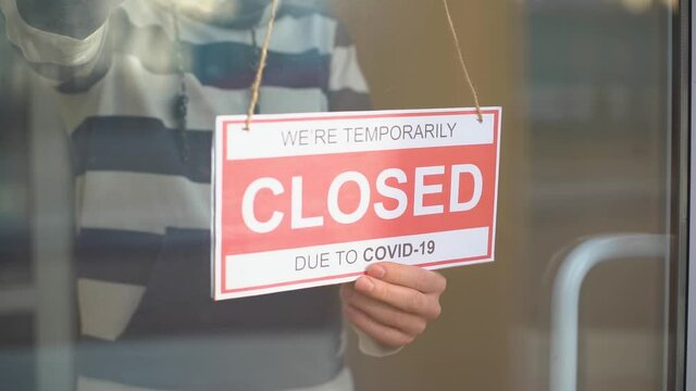 Closed for business due to covid. Small shop puts closed sign up on storefront