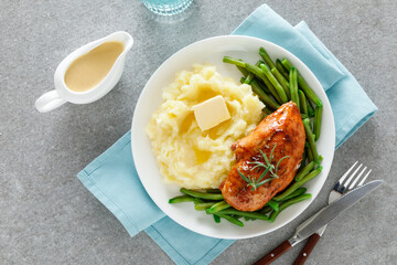 Roasted chicken breast with green beans and boiled mashed potatoes. Dinner or breakfast serving.