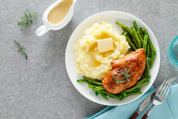 Roasted chicken breast with green beans and boiled mashed potatoes. Dinner or breakfast serving.